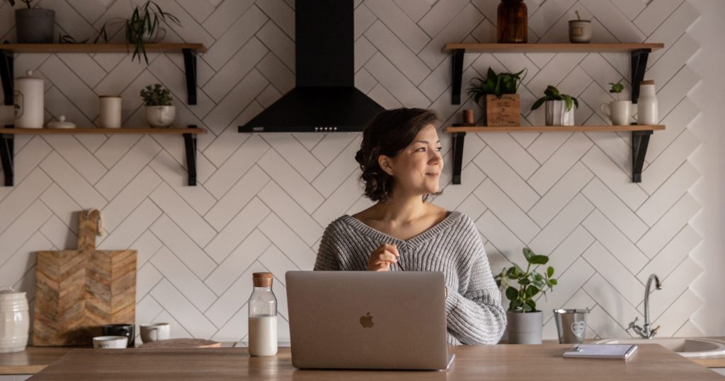 Girl working on her laptop in her student accommodation in London